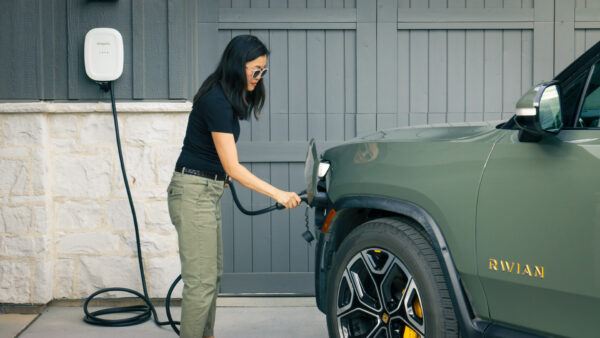 Emporia Classic Level 2 EV Charger being used outside by woman
