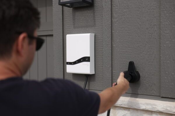 Emporia Pro Level 2 EV Charger being operated outside by man